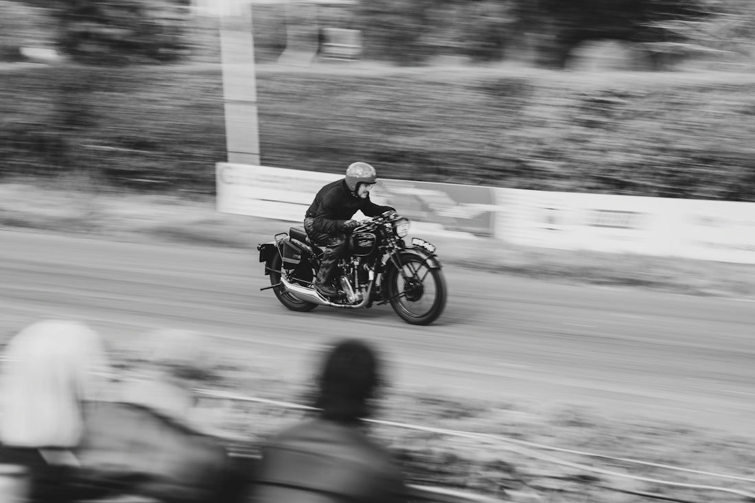 Motorcyclist racing on a dirt track with motion blur
